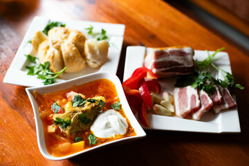 Traditional borscht with meat, salo and bread rustic homemade meal
