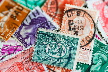 Postage stamps.A collection of world stamps in a pile.Postage stamps from different countries and times