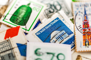 Postage stamps.A collection of world stamps in a pile.Postage stamps from different countries and times