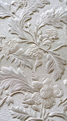 Close-up of embossed floral pattern, creamy white texture, showing detailed leaves and flowers, representative of elegance and classic design, ideal for background or wallpaper