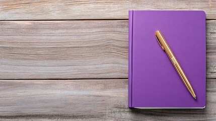 Violet pen resting on purple notebook on wooden surface for stationery design and inspiration