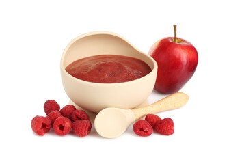 Baby food. Tasty puree in bowl, spoon, apple and raspberries isolated on white