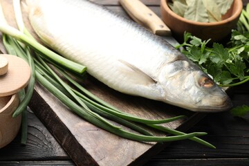 Tasty herring with spices on wooden table, closeup