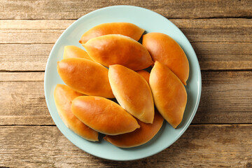 Tasty baked patties on wooden table, top view