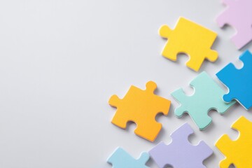 minimalistic arrangement of colorful puzzle pieces with intentional spaces embodying beauty of neurodiversity