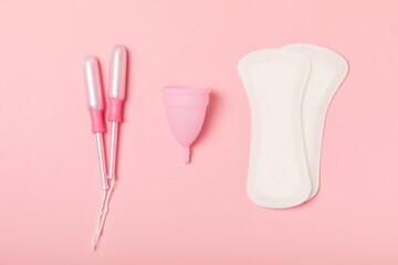Menstrual cup on a bright background. Sanitary napkins, tampons and menstrual cup.Concept of critical days, menstruation.feminine hygiene product. Women health concept.Premenstrual syndrome.Copy space