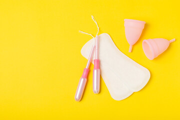 Menstrual cup on a bright background. Sanitary napkins, tampons and menstrual cup.Concept of critical days, menstruation.feminine hygiene product. Women health concept.Premenstrual syndrome.Copy space