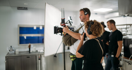 Director at work on the set. The director works with a group or with a playback while filming a...