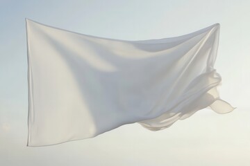 A piece of white cloth is stretched out and blows in the sky with light shadows and highlights on it, a bright airy scene.