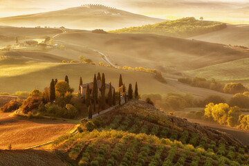 Landscape of hills, country road, cypresses trees and rural houses,Tuscany