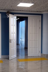 Fototapeta premium Open double door in white with iron silver handle.
