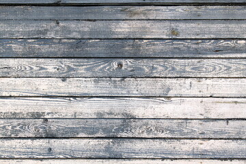 Old wooden wall with worn grey boards.