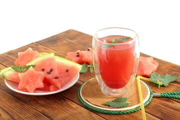 There is freshly squeezed watermelon juice on the wooden table.	