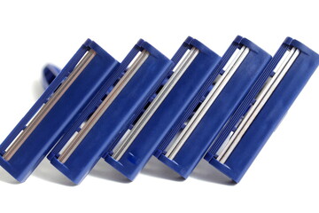 Several men's razors lie on a white background.	