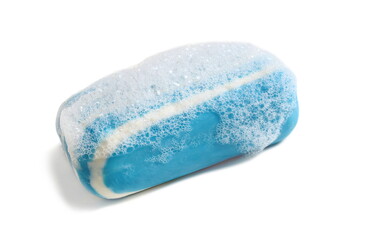 On a white background lies a striped blue soap with foam.	