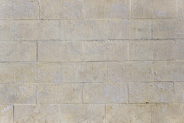 Fototapeta premium A wall made of white bricks. The bricks are the same size and arranged in a certain order.