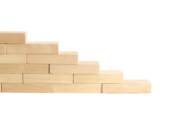On a white background there are wooden blocks stacked in a ladder.	
