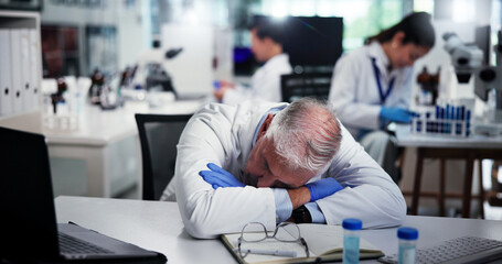 Tired, scientist and man sleeping in laboratory for burnout, deadline and exhausted with research. Medical science, fatigue and mature professional with stress, overworked and rest for low energy