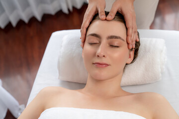 Caucasian woman enjoying relaxing anti-stress head massage and pampering facial beauty skin...