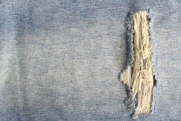 Denim background with torn pattern.