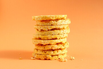 There is a stack of dry bread on an orange background.