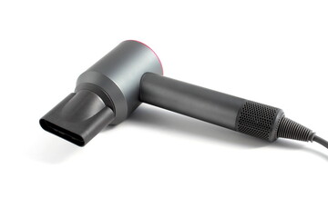 There is a gray hair dryer lying on a white background.