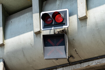 Red warning lights at the entrance to the tunnel mounted on a concrete pillar. Signaling for...