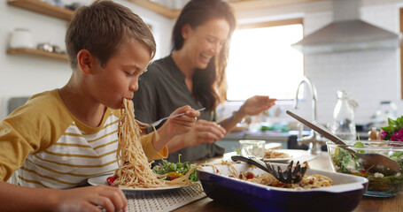Eating, food and pasta with family at kitchen table for nutrition, bonding and healthy growth....