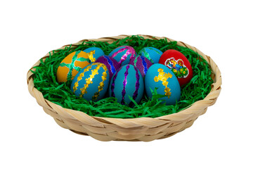 Easter eggs in a basket with artificial grass. The isolation is on a transparent background in the PNG format.