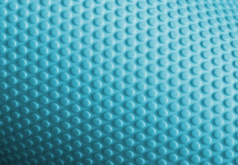Light blue textured surface with many small bumps creating repeating pattern