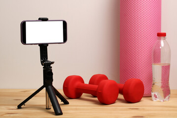 Home workout equipment with smartphone recording a fitness video blog. fitness at home.