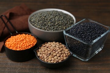 Different types of lentils on wooden table