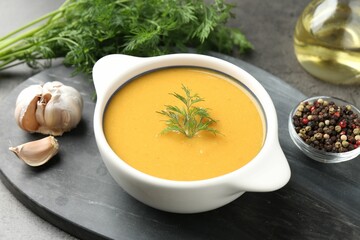 Delicious lentil cream soup with dill served on grey table, closeup