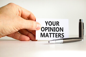 Your opinion matters symbol. Concept words Your opinion matters on beautiful white card. Beautiful white background. Businessman hand. Business your opinion matters concept. Copy space.