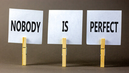 Nobody is perfect symbol. Concept words Nobody is perfect on beautiful white paper on clothespin....