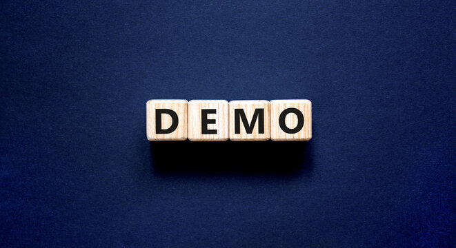 Demo symbol. Concept word Demo on beautiful wooden blocks. Beautiful black table black background. Business and demo concept. Copy space.