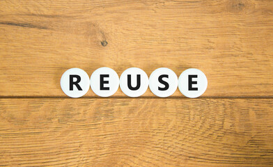 Reuse symbol. Concept word Reuse on beautiful white pills circles. Beautiful wooden table wooden background. Business lifestyle ecological reuse concept. Copy space.