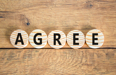 Agree symbol. Concept word Agree on beautiful wooden circles. Beautiful wooden table wooden...
