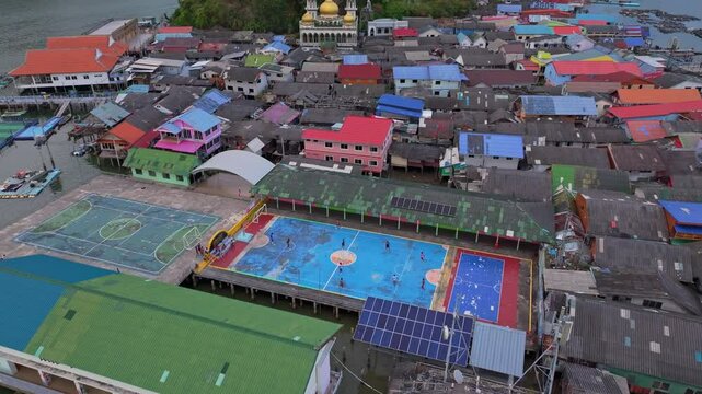 Aerial shot of Koh Panyi island with its floating soccer pitch, Thailand. Aerial drone video