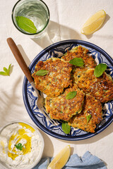 Home made courgette fritters on a blue plate-