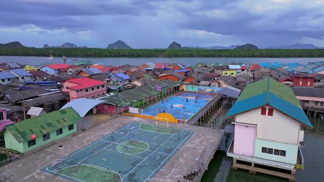 Phang Nga Bay floating soccer field at sunset, Koh Panyi, Thailand. Aerial drone video