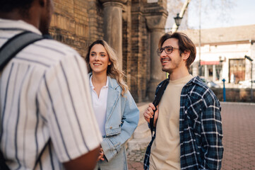 Students meeting and talking together outdoors in urban setting