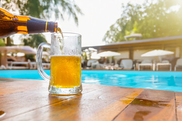 Cold Beer glass on the table at the open-air cafe.