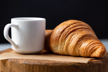 French Croissant And Cup Of Black Coffee Closeup View. Coffee Break Time