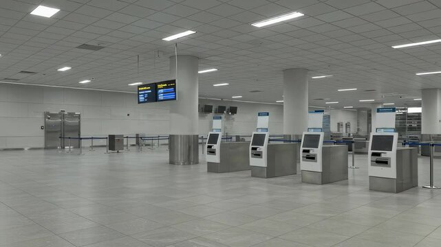 Empty check-in counters and security lines in airport terminal, no people inside. Concept of minimal travel or abandoned public space video footage background.
