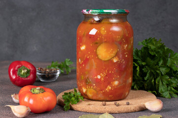 Cucumber and sweet pepper salad in tomato sauce in glass jar