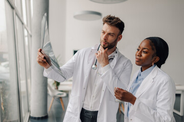 Doctors examining x ray for medical diagnosis in hospital