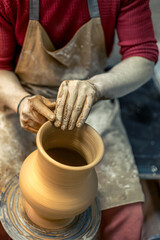 A male potter is making a vase. Pottery. Clay modeling. Making ceramics.