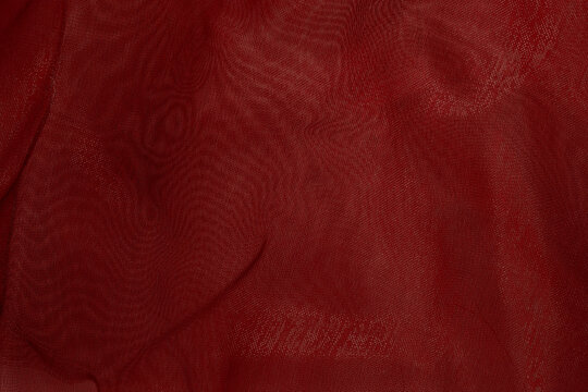 Sheer red tulle fabric with soft folds
 - Powered by Adobe