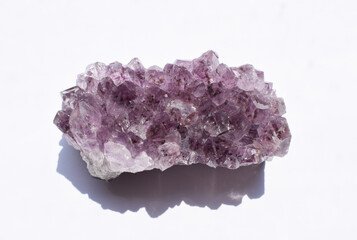 Beautiful druse of purple natural amethyst on a white background.